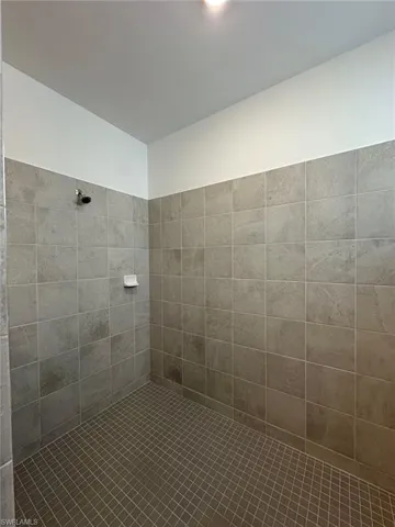 Full bath with a tile shower