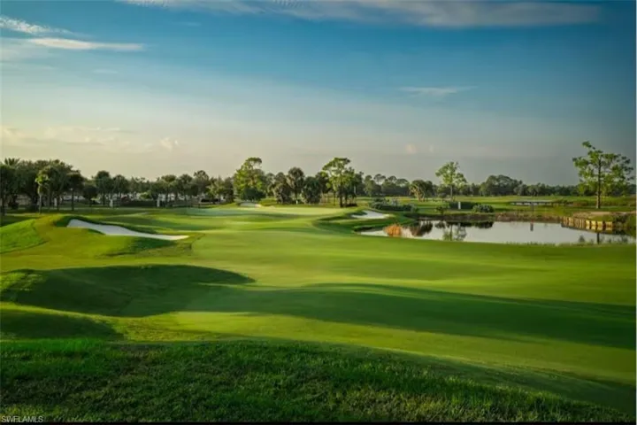 View of property's community featuring a water view, golf course view, and a lawn