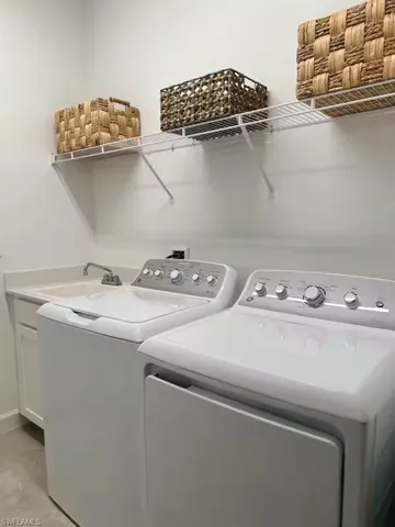 Laundry area with independent washer and dryer and a sink
