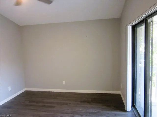Unfurnished room featuring dark wood-type flooring