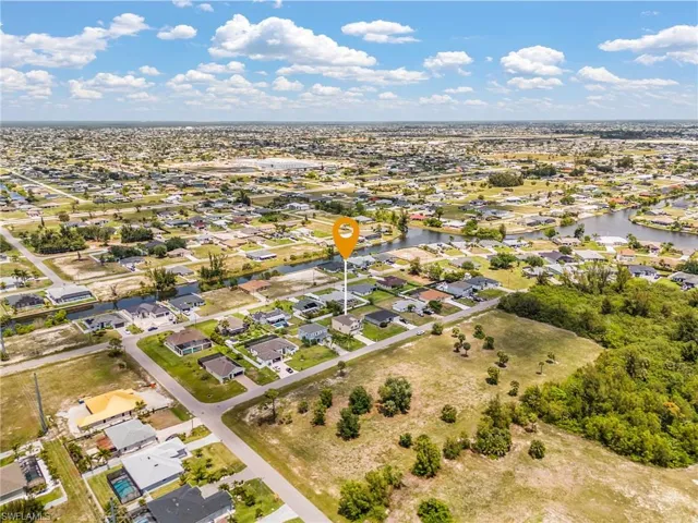 Aerial depiction of a residential area with multiple single-story homes and canals