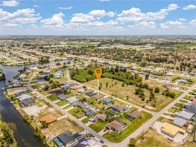 Aerial perspective showcasing the residential neighborhood with a prominent water canal