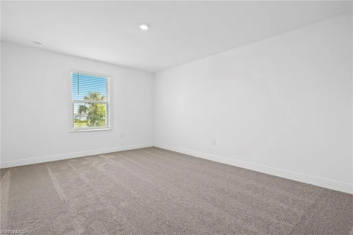 4rd Carpeted bedroom with baseboards.