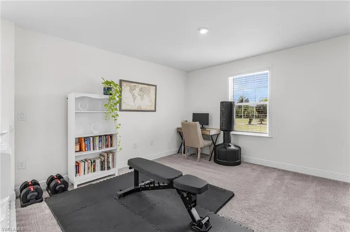 Carpeted room featuring a single window with blinds, and recessed ceiling lighting