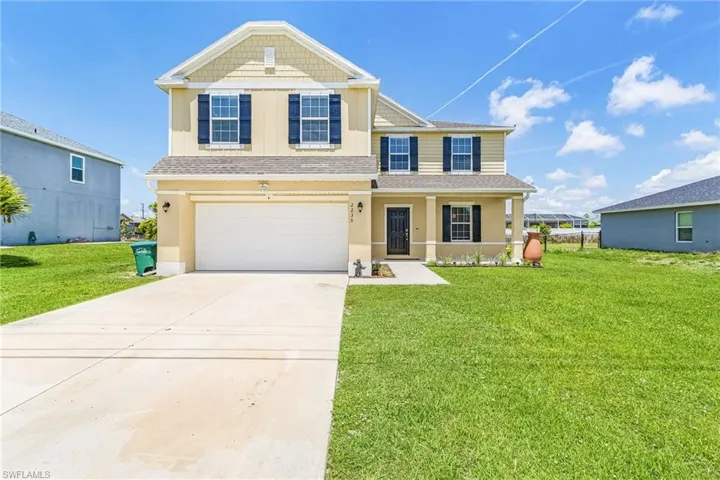 Two-story residence featuring a covered front entry porch with columns, a two-car garage, and a concrete driveway