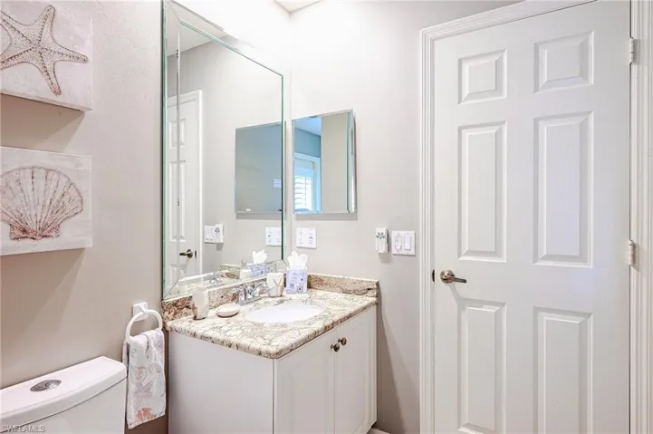 Half bath featuring vanity and toilet