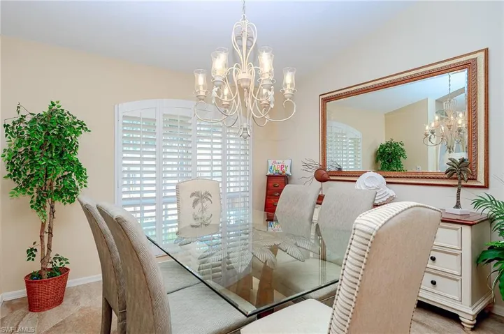 Dining space with baseboards and a notable chandelier