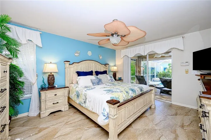Bedroom with access to exterior, baseboards, and ceiling fan