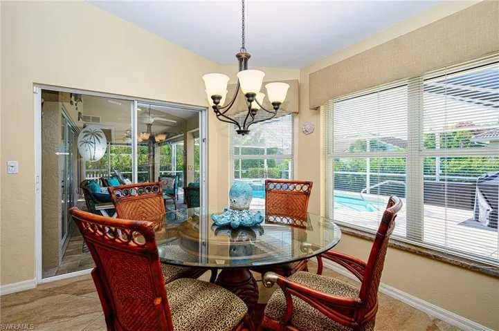 Dining room featuring baseboards and a notable chandelier