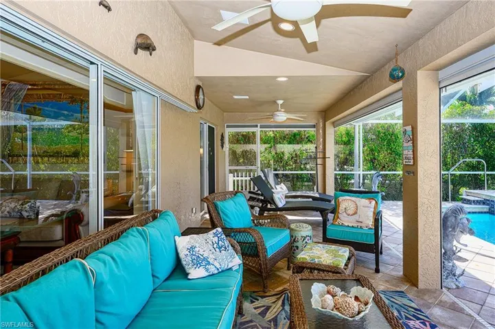 Sunroom with a textured wall and a ceiling fan