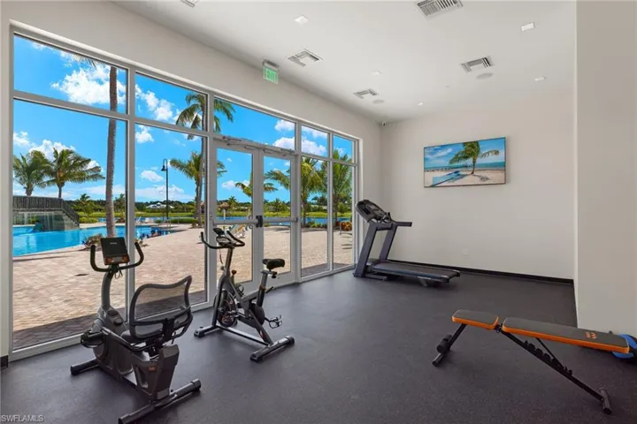 Exercise room featuring french doors to the pool