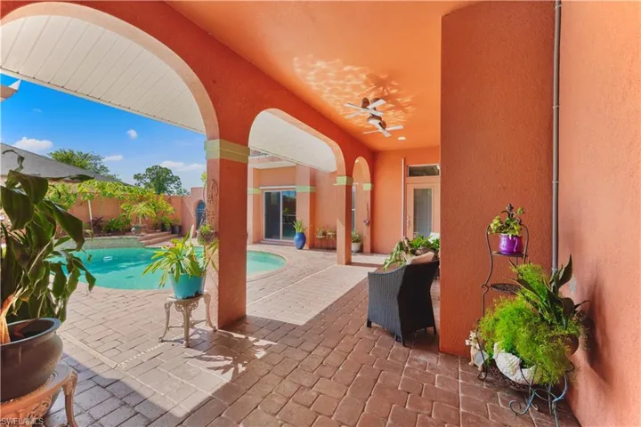 View of swimming pool with a patio, a fenced backyard, and ceiling fan
