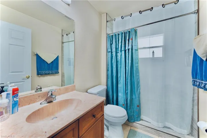 Full bath with vanity and curtained shower