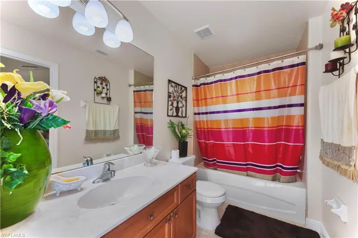 Bathroom with vanity and shower / tub combo with curtain