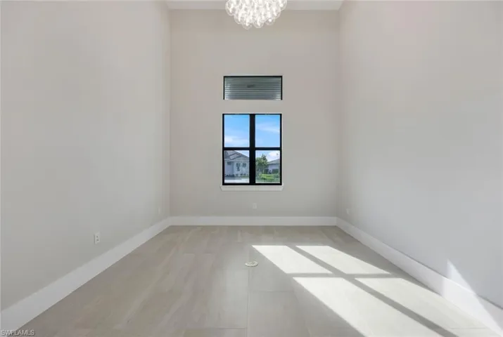 Empty room with a notable chandelier