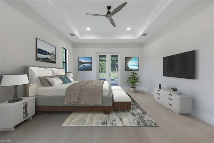 Virtually staged Photo.  Bedroom with french doors, recessed lighting, visible vents, access to outside, and a tray ceiling