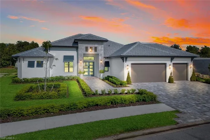 Prairie-style house featuring french doors, a garage, and a lawn