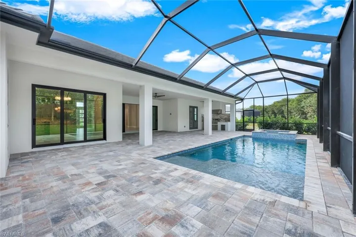 View of swimming pool featuring a patio, area for grilling, an in ground hot tub, a lanai, and ceiling fan
