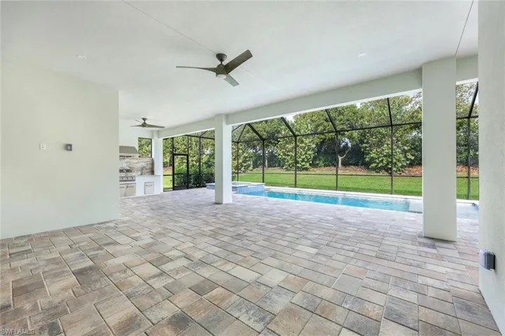 View of pool with area for grilling, a patio area, and ceiling fan