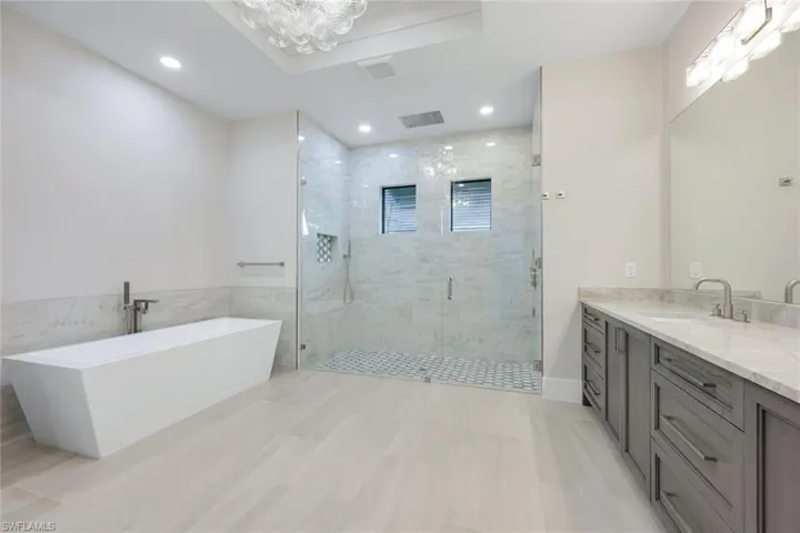Bathroom featuring vanity and shower with separate bathtub