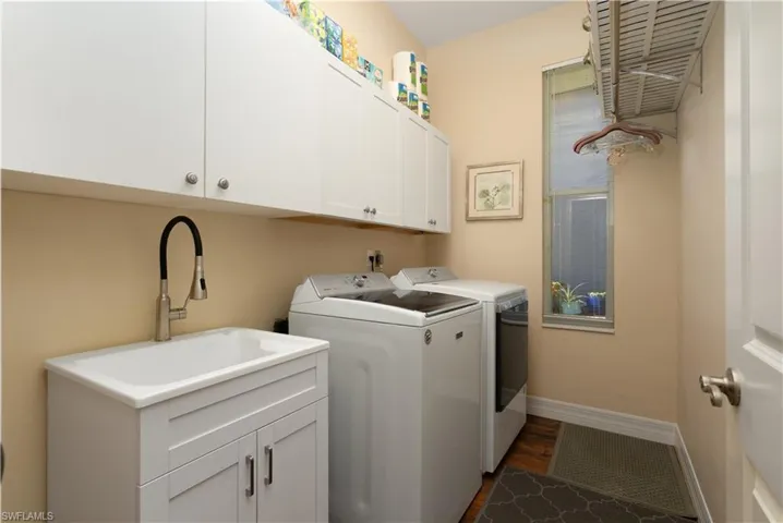 Laundry area with a sink and extra cabinets