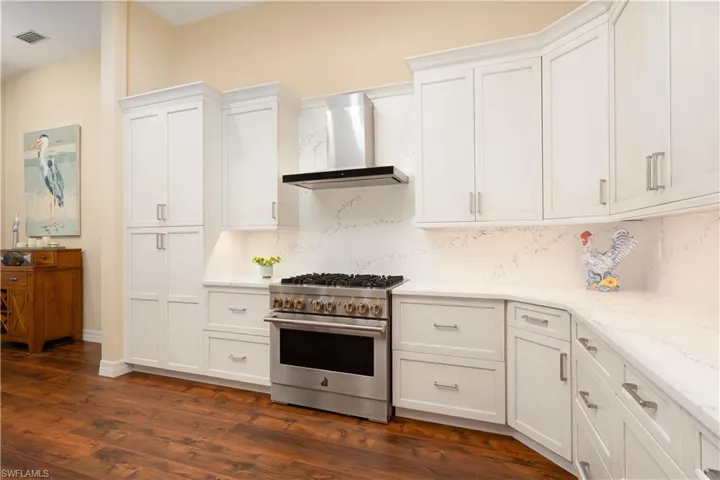 Kitchen featuring wall chimney range hood
