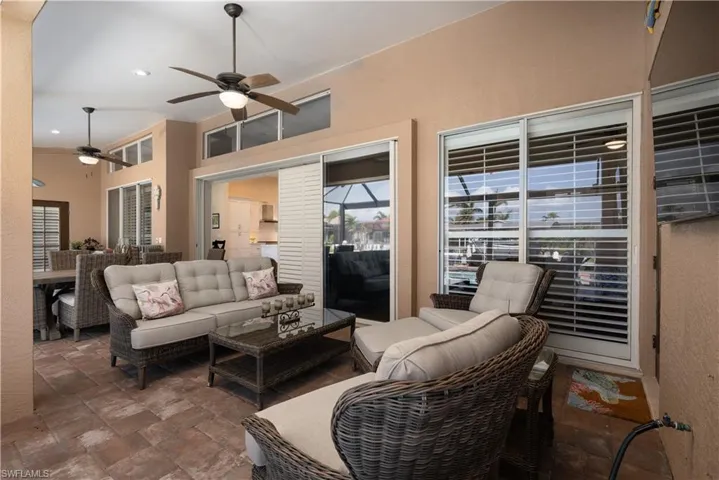 Large covered patio area with fans and pavers