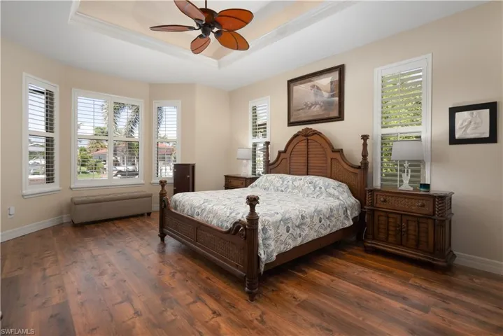 Primary bedroom with bay window and plantation shutters