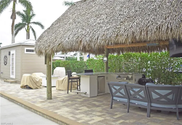 View of patio / terrace with area for grilling and outdoor dry bar