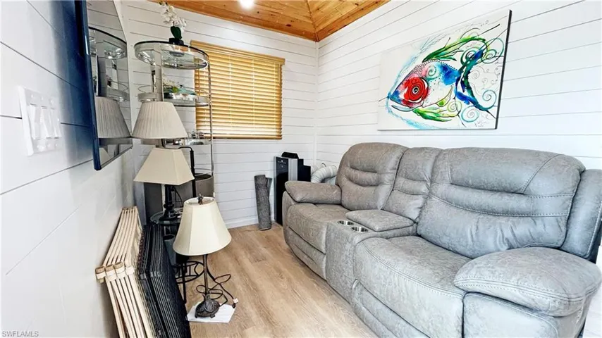 Living room featuring wood walls and wood finished floors