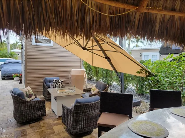 View of patio / terrace featuring outdoor dining area and an outdoor living space with a fire pit