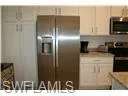 Kitchen featuring appliances with stainless steel finishes and light countertops