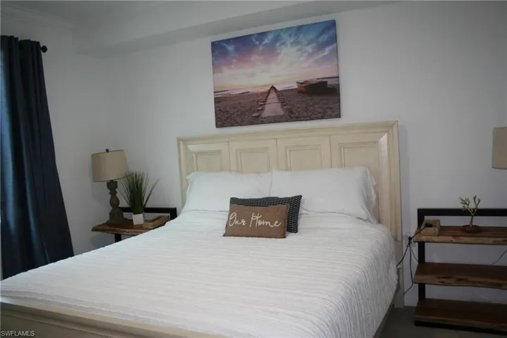 Carpeted bedroom with crown molding