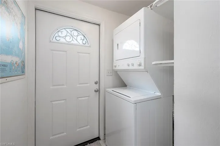 Washroom featuring stacked washer and dryer