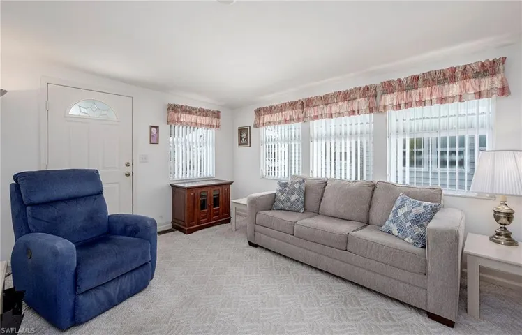 Living room featuring light colored carpet