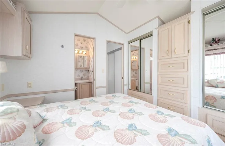Bedroom featuring lofted ceiling and a closet