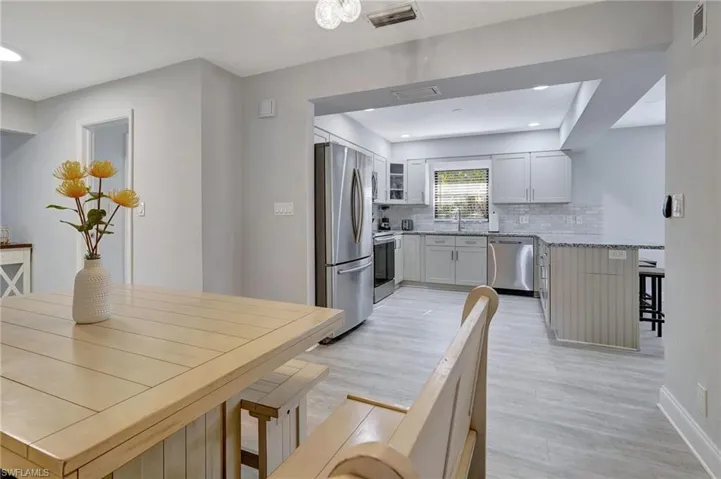 Dining area with sink and light hardwood / wood-style floors