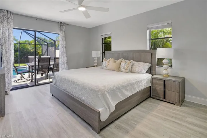 Bedroom with ceiling fan, light hardwood / wood-style floors, and access to exterior