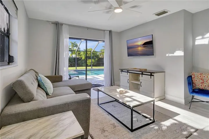 Living room featuring light hardwood / wood-style flooring and ceiling fan