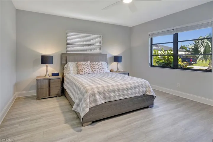 Bedroom with ceiling fan and light hardwood / wood-style floors