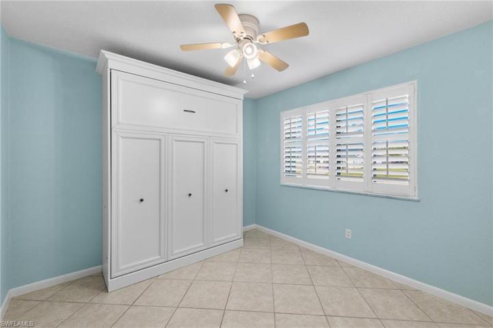 Guest bedroom with plantation shutters and Murphy Bed.