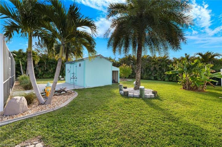Nicely landscaped backyard with shed and pond water feature.
