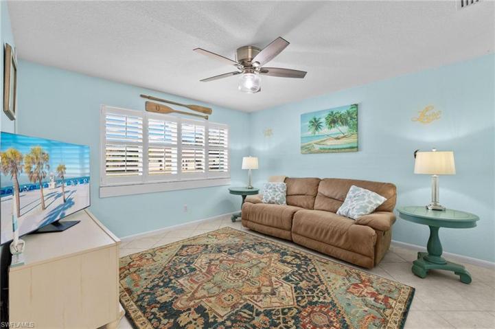Family room with plantation shutters at the window.