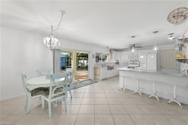 Dining and kitchen area with access to pool and backyard.