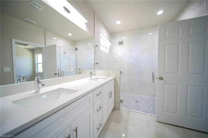 The Master Bathroom Comes With Dual Sinks, Quartz Countertops, Flat Panel Real Wood Cabinets & Drawers, And A Walk-In Glass Tiled Shower With Seating!