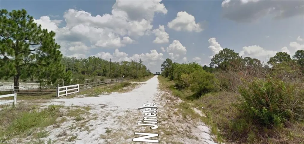 View of dirt / gravel road featuring a view of countryside