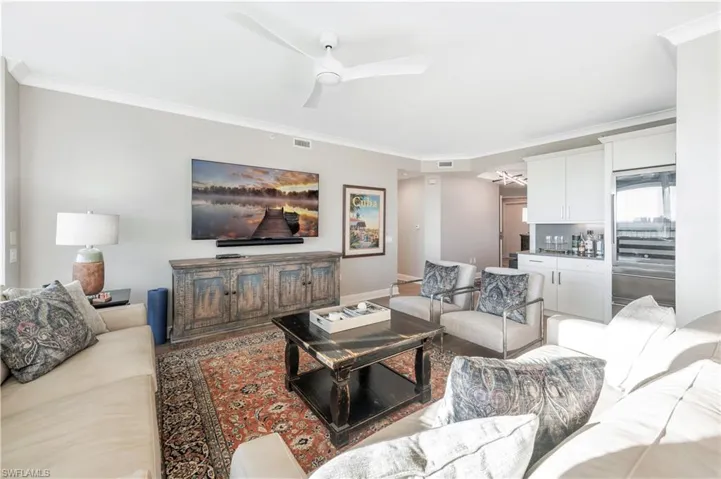 Living room featuring crown molding and ceiling fan