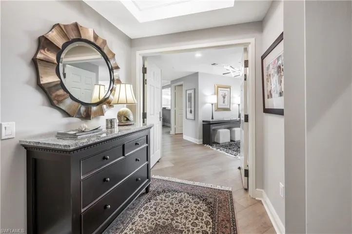 Hallway featuring light hardwood / wood-style floors and a skylight