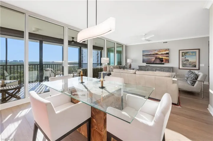 Dining area featuring floor to ceiling windows, light hardwood / wood-style flooring, ceiling fan, and ornamental molding