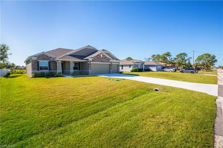 View of front of property with a garage and a front yard